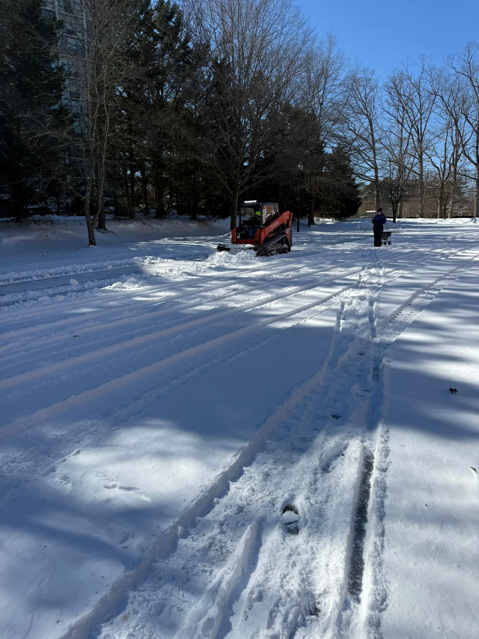 Home 17 Fonvilletreeservice crew operating red compact track loader clearing snow from residential property in NC winter conditions